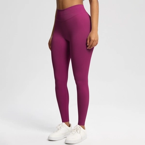 Detail of high-waisted seamless rose red yoga pants with tummy control and peach lift effect