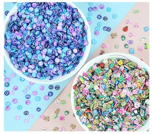 Macro detail of 5mm polymer clay slices featuring zodiac signs and cute animal designs