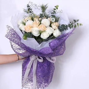 Floral bouquet with roses and eucalyptus wrapped in purple jacquard hollow mesh net