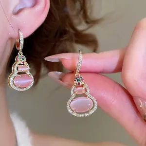 14k gold plated gourd earrings with pink cat eye stone and cubic zirconia accents