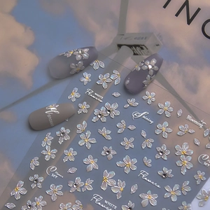Detailed 3D embossed white flower nail stickers with pearl finish and gold center accents