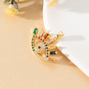 Macro shot of evil eye pendant with colorful cubic zirconia and gold finish detail