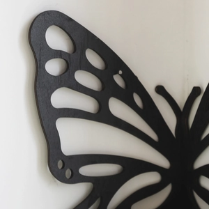 Detailed view of hollow butterfly wooden crystal shelf with black metal finish on wall