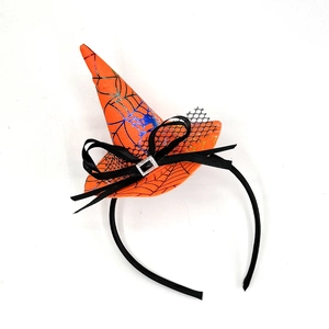 Detail of orange Halloween witch hat headband with blue spider web patterns and bow