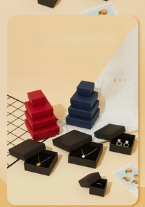 Detailed view of luxury cardboard jewelry boxes in red, navy, and black with sponge lining