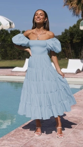 Close-up of light blue puff sleeve dress featuring ruffled detail and off-shoulder neckline