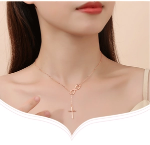 Close-up of rose gold 925 silver infinity cross necklace on model neck detail