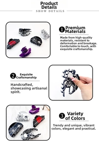 Detail shot of Halloween hair claws featuring skull and spider web acrylic patterns