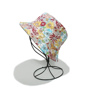Detailed close-up of vibrant sunflower pattern on cotton bucket hat for sun protection