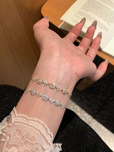 Detailed view of 18K gold and silver plated adjustable flower bracelets with zircon stones