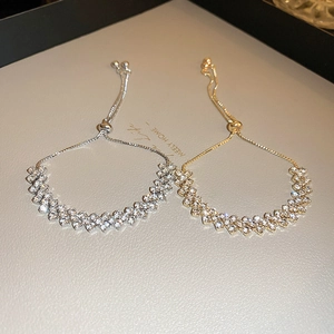 Luxurious silver and gold adjustable bracelets with crisscross diamond-studded geometric patterns