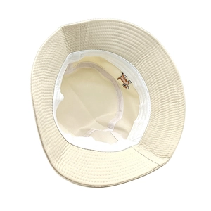 Beige cotton bucket hat featuring cute dog embroidery and detailed inner stitching