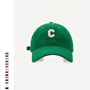 Detail of green cotton baseball cap with cream-colored Chenille letter C embroidery