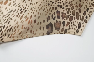 Macro shot of high-quality leopard print fabric texture with brown and black patterns