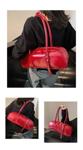 Macro shot of glossy red cylinder bag showing shiny PU leather texture and shoulder straps