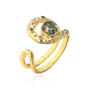 Detail of adjustable gold ring featuring hammer texture and colorful artisan glass eye