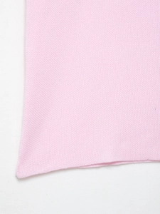 Detailed close-up showing the fine knit texture and soft pink fabric of the sleeveless top