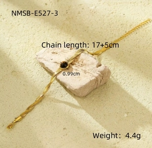Detailed shot of golden snake chain bracelet with brown tiger eye stone on stone stand