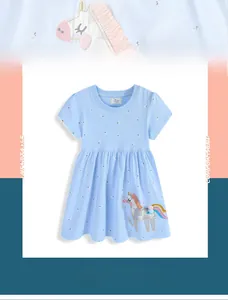 Close-up of unicorn embroidery with fringe detail on a blue floral girl's dress