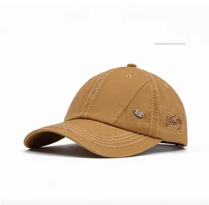 Detail of khaki cotton baseball cap with FreeStyle embroidery and metal button accent