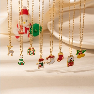 Close-up of gold-plated Christmas pendant necklaces featuring reindeer and snowman designs