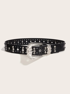 Detail of black faux leather belt with crocodile texture and rhinestone butterfly buckle