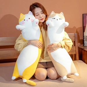 Detail of soft yellow and beige long cat plush pillows held for comfort size reference