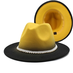 Detail of wide brim wool fedora featuring yellow-black gradient and pearl bead band