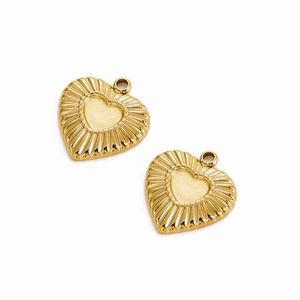 Detailed view of golden heart pendants with radial sunburst texture for jewelry DIY