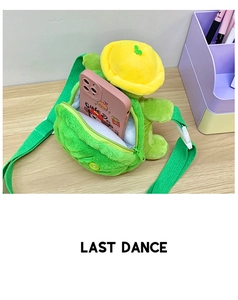 Detail of cute green turtle plush crossbody bag interior showing storage capacity