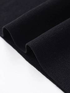 Macro shot of high-density black ribbed knit fabric texture with fine vertical lines