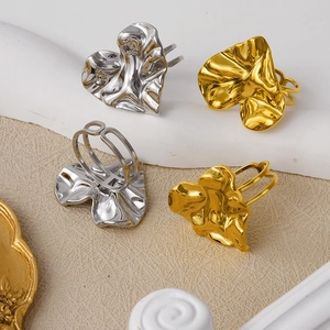 Detailed view of 304 stainless steel heart rings with gold and silver wrinkled texture