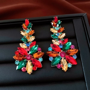 Close-up of vintage floral glass pendant earrings with multi-color rhinestones in a box