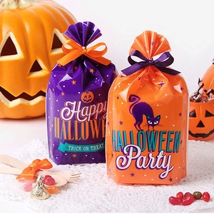 Halloween gift bags with pumpkin and black cat prints, including orange and purple ribbons