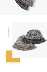Detail view of thick knit fisherman hats in mixed grey and beige with textured wool fabric