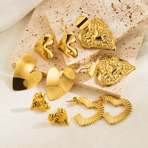 Set of five gold heart-shaped earrings in polished, hammered, and embossed metal styles
