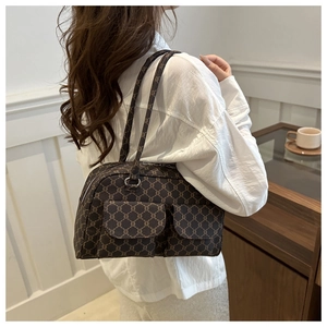 Brown vintage monogram shoulder bag styled by a model in an elegant French cafe setting