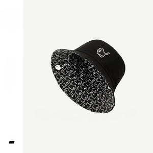 Detail of reversible bucket hat with cat embroidery and black-white contrast inner lining