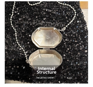 Octagonal silver metal mini bag showing interior structure and bead chain strap