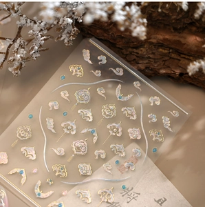 Detail of 3D embossed cloud nail stickers with gold accents in New Chinese style