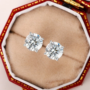 Macro shot of brilliant round cut zircon earrings in a four-prong silver setting box