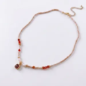 Elegant beaded necklace with red crystal pendant and small pearls for women