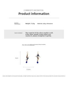 Detail shot of vintage crane earrings with blue teardrop stones and rhinestone inlay