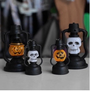 Set of four Halloween LED lanterns featuring glowing pumpkin and skull designs on a white surface