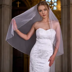 Elegant white bridal veil with handcrafted bead fringe and comb in a cathedral setting