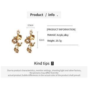 Detailed view of long gold petal earrings with size metrics 2.5cm by 12cm