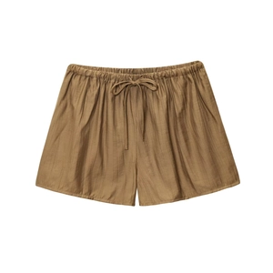 Detail of tan crinkled fabric shorts with elastic waistband and adjustable drawstring