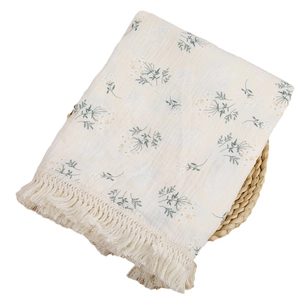 Double-layer cotton muslin baby fringe blanket with floral pattern on woven basket