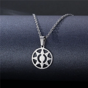 Macro detail of silver geometric hollow circular pendant on stainless steel chain