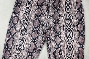 Detailed view of the pink and purple snake print texture on slim-fit flared trousers